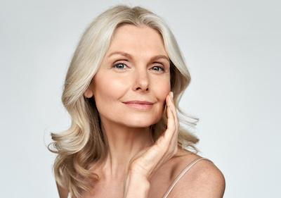 woman touching her left cheek