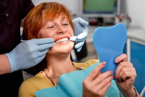 red hair woman sitting in a dental chair