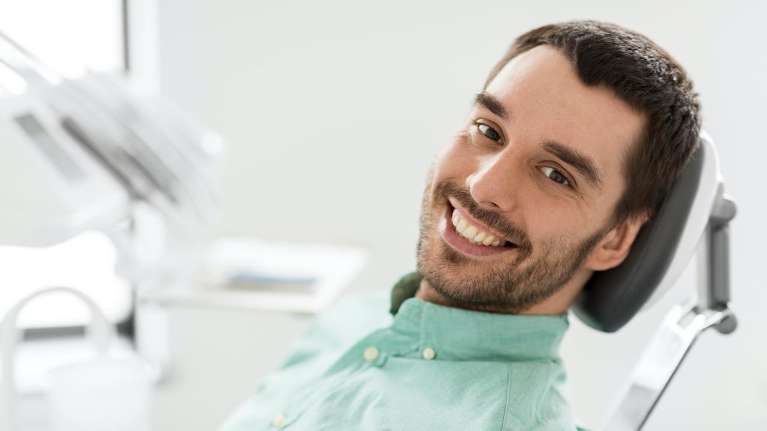 man sitting in a dental chair